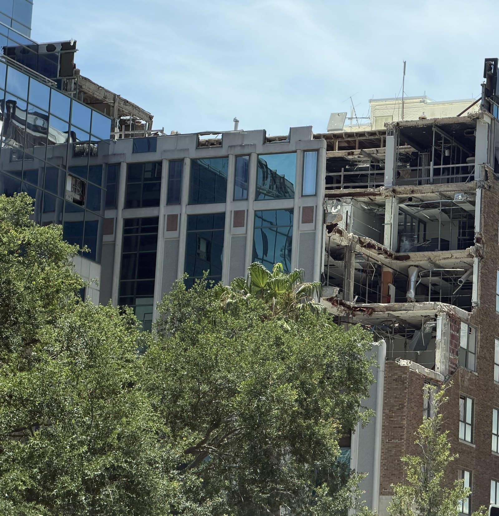 Exposed structural framing of a Florida high-rise during a milestone inspection repair: the load-bearing concrete and rebar that SIRS studies and Chapter 718/720 compliance are built around.
